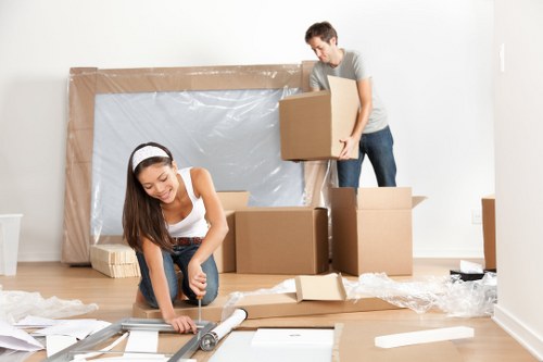 Removal team loading household boxes into a vehicle