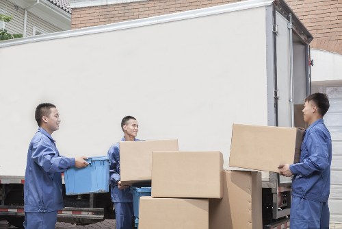 Careful loading of boxes and household items into a removals van