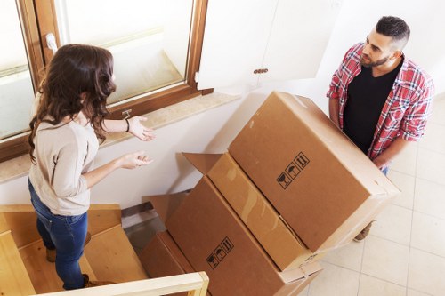 Prepared moving boxes and furniture outside a Hounslow home