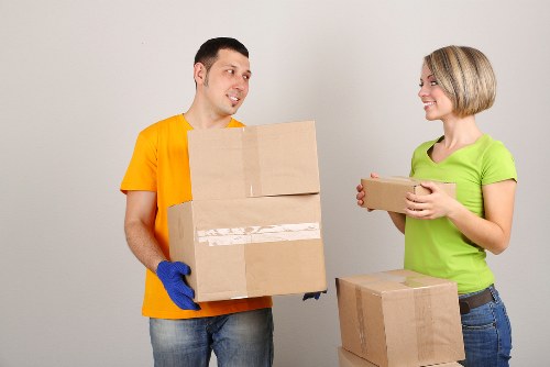 Move team transporting office equipment through a Hounslow commercial building